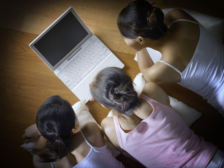 Friends watching movie on laptopの写真素材