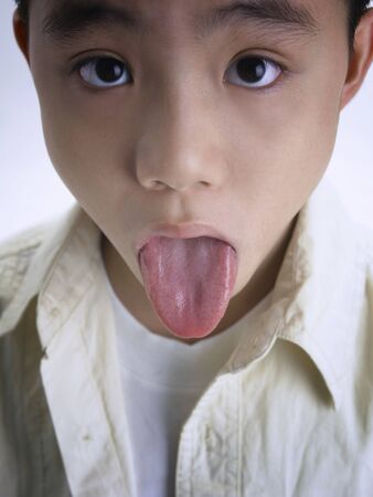 Boy sticking his tongue outの写真素材