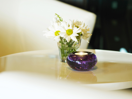 Close up of table with candle and flowerの写真素材