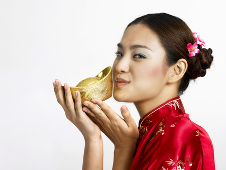 woman kissing gold ingotの写真素材