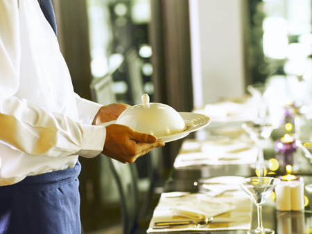 Close up of waiter cleaning up the plateの写真素材