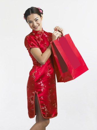 woman holding shopping bag happilyの写真素材