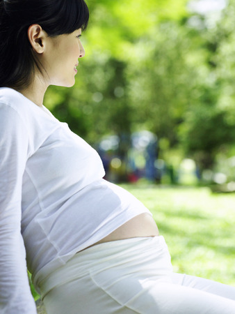 pregnant woman in the parkの写真素材
