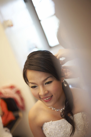 Reflection of bride fixing her hairの写真素材
