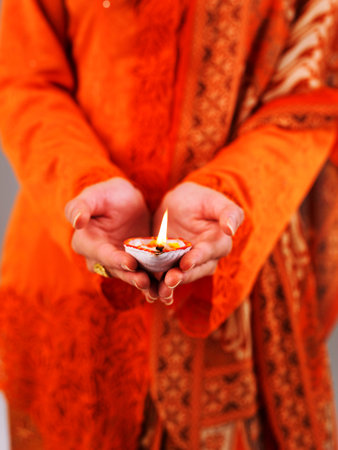 A malay lady holding indian oil lampの写真素材