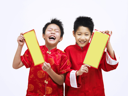 two happy boys with chinese coupletの写真素材