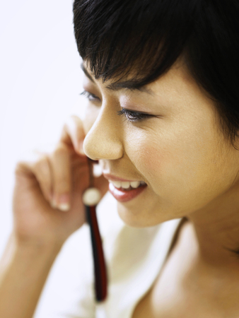 profile of the woman talking on the phoneの写真素材