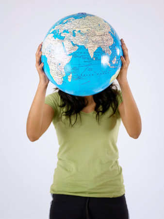 young woman  holding a globe cover her face