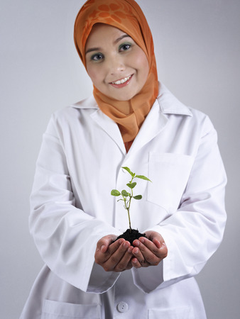 Malay woman holding growing seedの写真素材