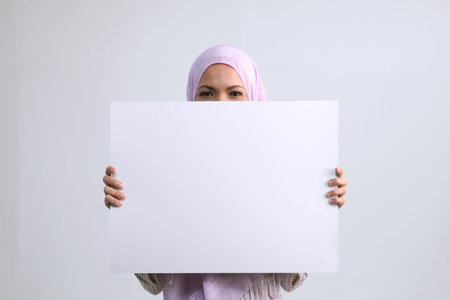 Woman holding white card boardの写真素材