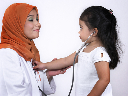 Close up of a girl examining a woman using stethoscopeの写真素材