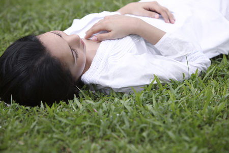 High angle view of woman lying on grassの写真素材