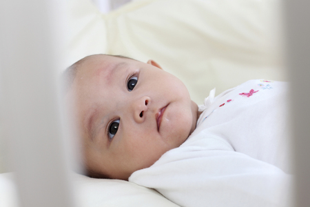 Selective view of baby in a bedの写真素材