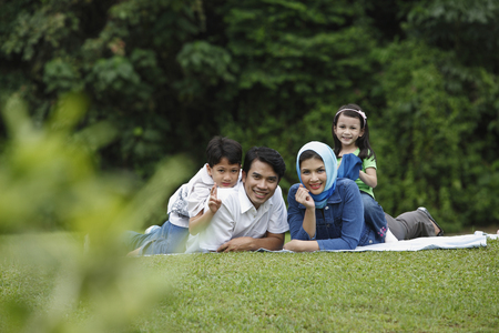 malay family having fun at the parkの写真素材