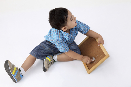 top view  of the boy drawing at small blackboardの写真素材
