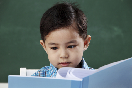stock iamge of the schoolboy holding a textbookの写真素材