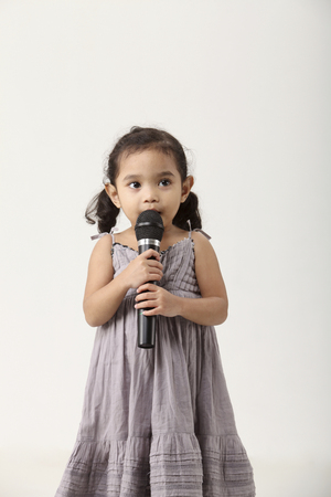 Asian little girl singingの写真素材