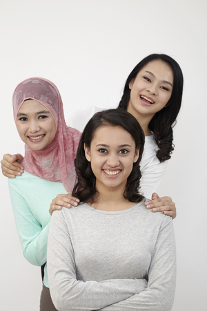 Malaysian three multi racial looking at cameraの写真素材