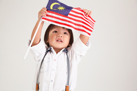 chinese boy holding malaysia flagの写真素材