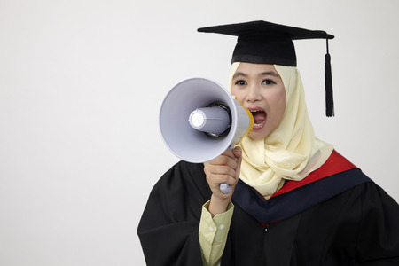 Graduation student shouting through megaphoneの写真素材