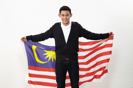 young malay teenage holding malaysia flagの写真素材