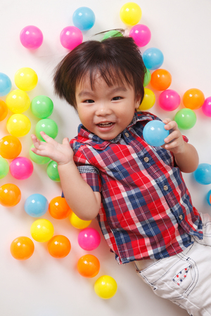 top view of chinese boy playing with colorful ballsの写真素材