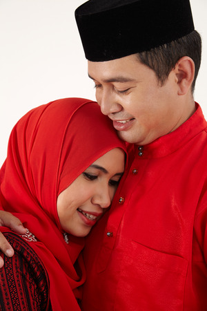malay man hugging his wifeの写真素材