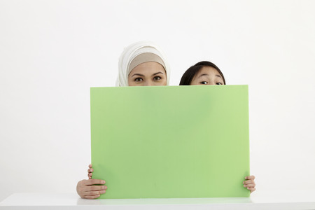 mother and daughter holding placardの写真素材