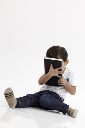 Malay boy cover with black cover bookの写真素材