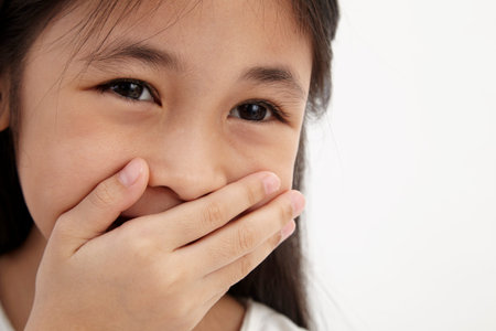 girl closed her mouth feeling funny
