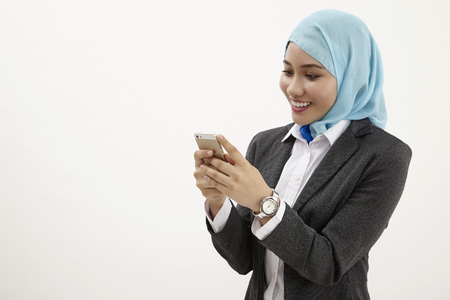 malay business woman  reading using mobile phoneの写真素材