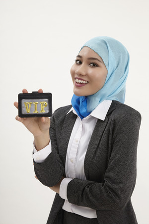 malay business woman holding a vip pass cardの写真素材