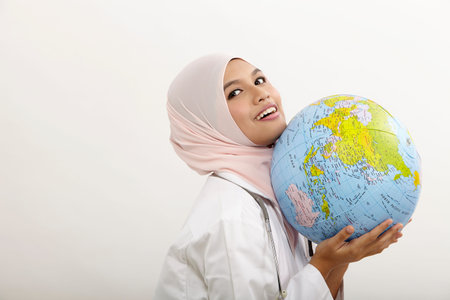 malay female doctor holding globe on the white background