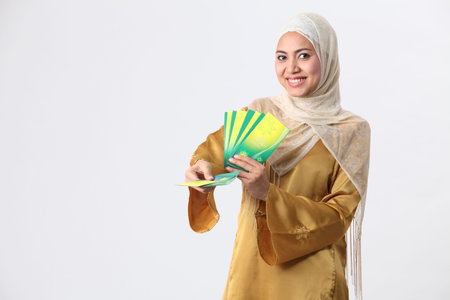 Malay woman giving away green packets.