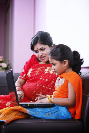 Mother and daughter using laptopの写真素材