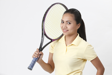 Malay woman holding tennis racquet.の写真素材