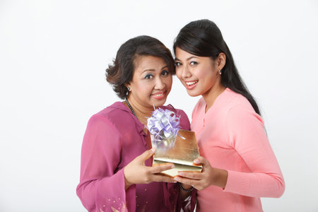 Mother and daughter holding gift boxの写真素材