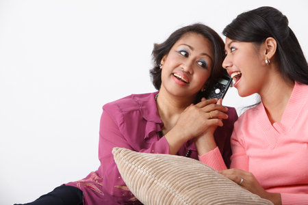 Mother and daughter listening to phone