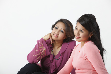 profile of mother and daughter looking awayの写真素材