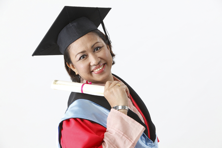 Side view of senior woman in graduation gownの写真素材