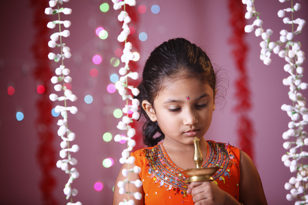 Indian girl holding oil lampの写真素材