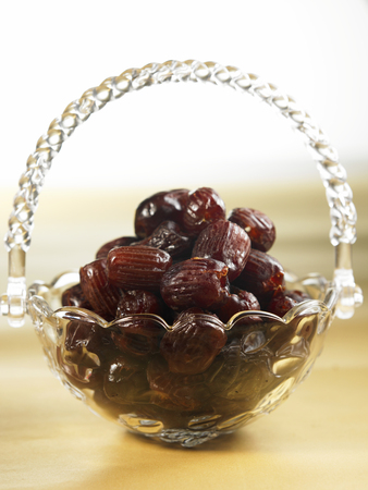 dates in a glass basketの写真素材