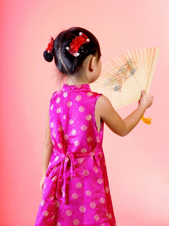 A girl holding a wooden made fanの写真素材