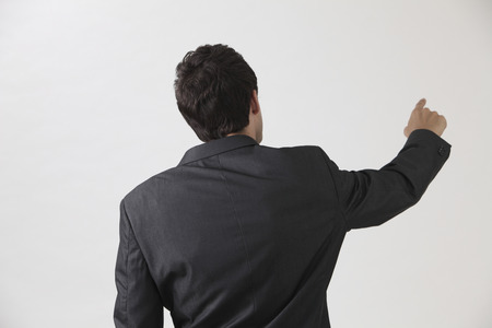 Businessman from behind, pointing at somethingの写真素材