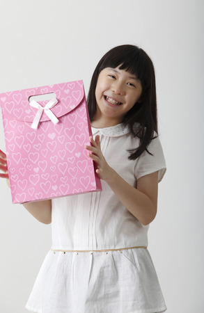 chinese girl holding a present bagの写真素材