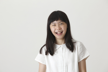 portrait of chinese girl laughing looking at cameraの写真素材
