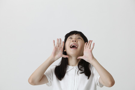 chinese girl screaming and looking upの写真素材