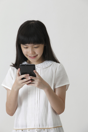chinese girl happy reading smsの写真素材