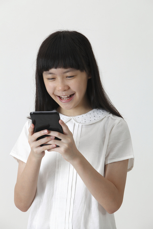 chinese girl happy reading smsの写真素材