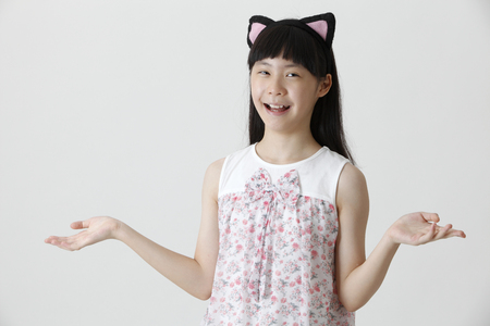 portrait of chinese girl with cute hair band laughingの写真素材